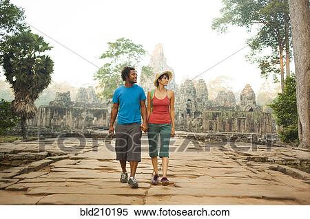 Stock Photography - Couple visiting ancient temple, Angkor, Siem Reap, Cambodia. Fotosearch