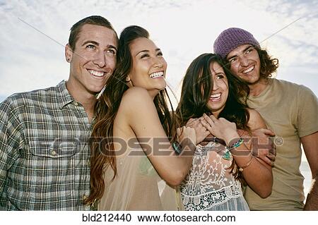 Stock Image - Couples smiling together outdoors. Fotosearch