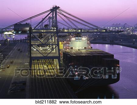 Stock Image - Cranes over container ship, Port of Los Angeles, California, United States. Fotosearch