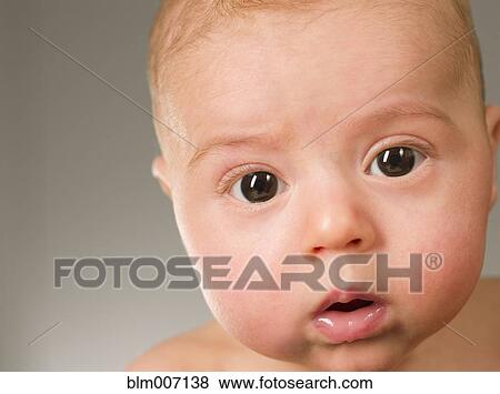 Stock Photo - Curious mixed race newborn baby. Fotosearch