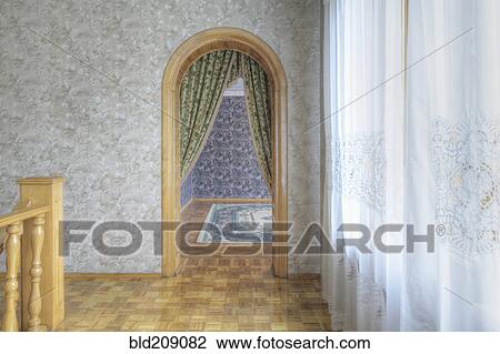 Stock Image - Curtains over archway in house. Fotosearch
