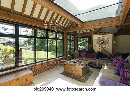 Cushioned benches in sunny conservatory View Large Photo Image Stock Image - Cushioned benches in sunny conservatory. Fotosearch