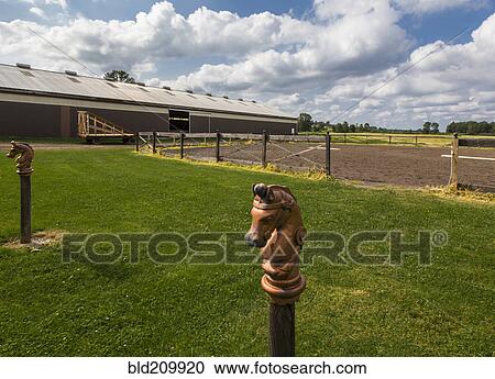 Stock Image - Decorative horse posts on farm. Fotosearch
