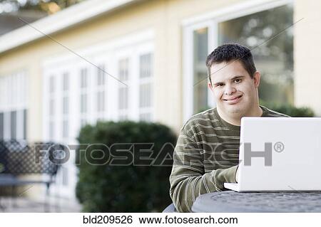 Disabled Caucasian man using laptop outdoors View Large Photo Image Stock Photograph - Disabled Caucasian man using laptop outdoors. Fotosearch