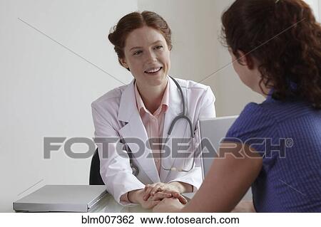 Doctor comforting patient View Large Photo Image Stock Image - Doctor comforting patient. Fotosearch
