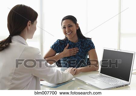 Doctor talking to patient in doctor's office View Large Photo Image Stock Image - Doctor talking to patient in doctor's office. Fotosearch