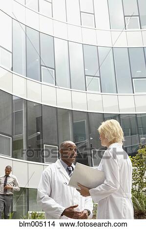 Doctors talking in hospital courtyard View Large Photo Image Picture - Doctors talking in hospital courtyard. Fotosearch