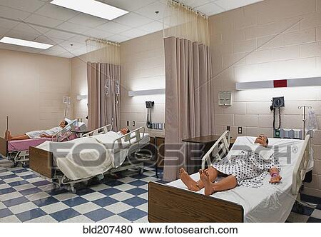 Stock Image - Dummy patients laying in hospital beds. Fotosearch