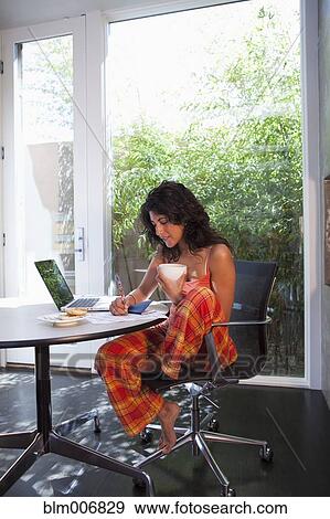Ecuadorian woman drinking coffee and using laptop View Large Photo Image Stock Photo - Ecuadorian woman drinking coffee and using laptop. Fotosearch