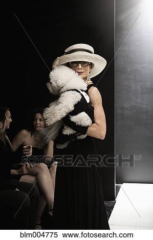 Stock Photography - Elegant Caucasian woman with dog at fashion show. Fotosearch