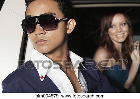 Stock Photo - Elegant couple getting out of car. Fotosearch