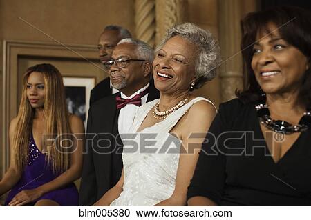 Elegantly dressed people in nightclub View Large Photo Image Stock Image - Elegantly dressed people in nightclub. Fotosearch