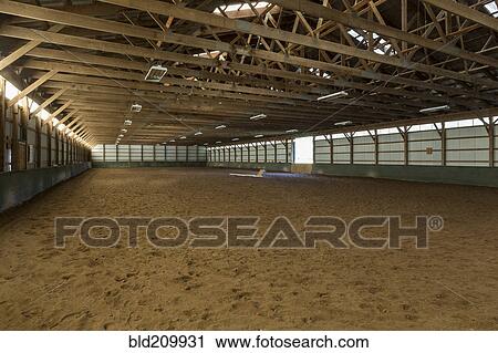 Stock Image - Empty indoor horse riding ring. Fotosearch