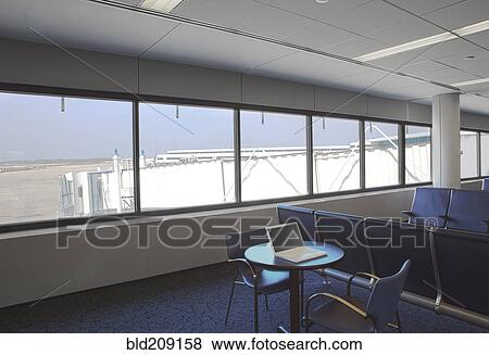 Stock Photo - Empty waiting area overlooking runway in airport. Fotosearch
