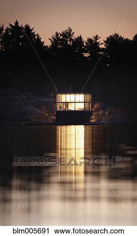 Exterior of modern house and lake at dusk View Large Photo Image Stock Image - Exterior of modern house and lake at dusk. Fotosearch
