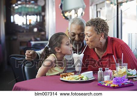 Family drinking from straws in restaurant View Large Photo Image Picture - Family drinking from straws in restaurant. Fotosearch