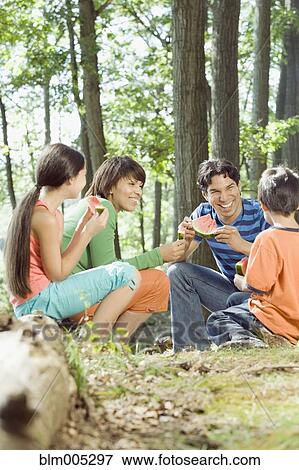 Family eating watermelon in forest View Large Photo Image Stock Photo - Family eating watermelon in forest. Fotosearch