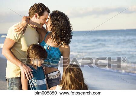 Stock Image - Family enjoying beach. Fotosearch