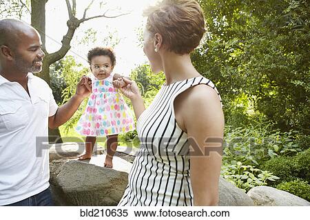 Family playing together in park View Large Photo Image Stock Photography - Family playing together in park. Fotosearch