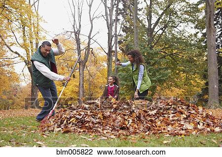 Family raking autumn leaves View Large Photo Image Stock Image - Family raking autumn leaves. Fotosearch