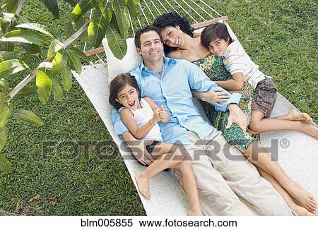 Stock Photography - Family relaxing in hammock. Fotosearch