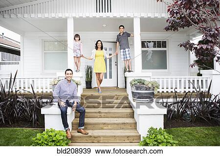 Stock Photo - Family smiling together on porch. Fotosearch