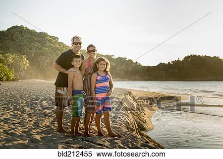 Family standing together on beach View Large Photo Image Stock Photography - Family standing together on beach. Fotosearch