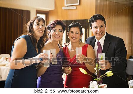 Stock Photography - Family toasting each other at wedding reception. Fotosearch