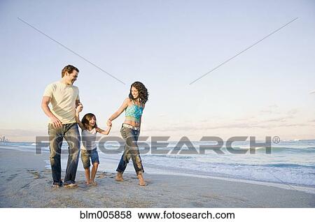 Family walking on beach View Large Photo Image Stock Photo - Family walking on beach. Fotosearch