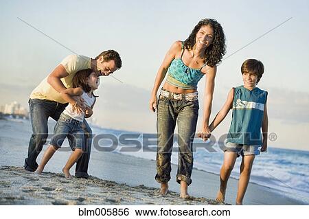 Family walking on beach View Large Photo Image Stock Photograph - Family walking on beach. Fotosearch