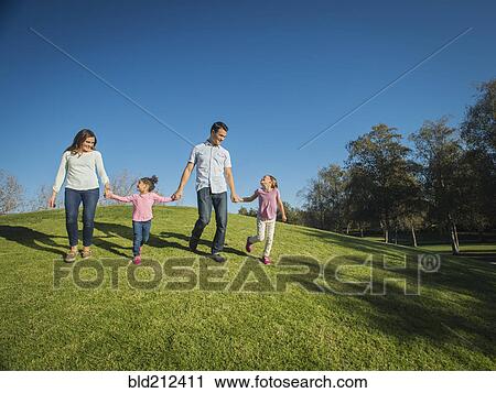 Family walking together in park View Large Photo Image Stock Image - Family walking together in park. Fotosearch