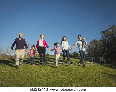 Family walking together in park View Large Photo Image Stock Image - Family walking together in park. Fotosearch