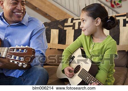 Father and daughter playing guitar together View Large Photo Image Picture - Father and daughter playing guitar together. Fotosearch