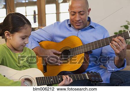 Father and daughter playing guitar together View Large Photo Image Stock Image - Father and daughter playing guitar together. Fotosearch
