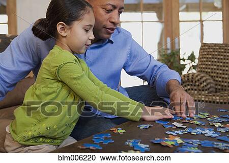 Father and daughter putting together puzzle View Large Photo Image Stock Image - Father and daughter putting together puzzle. Fotosearch