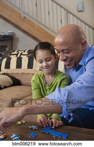 Father and daughter putting together puzzle View Large Photo Image Stock Photo - Father and daughter putting together puzzle. Fotosearch