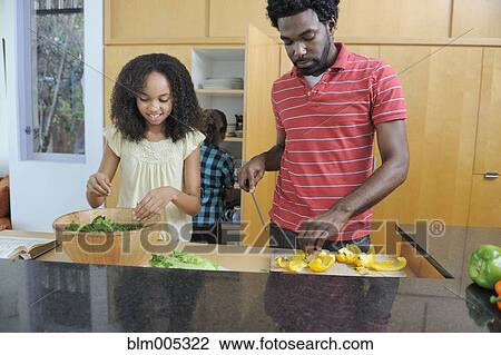 Father and daughters preparing food in kitchen View Large Photo Image Stock Image - Father and daughters preparing food in kitchen. Fotosearch