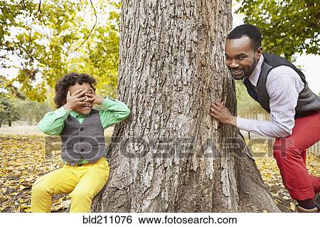 Stock Photograph - Father and son playing in park. Fotosearch