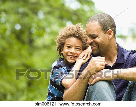 Father and son smiling outdoors View Large Photo Image Stock Image - Father and son smiling outdoors. Fotosearch
