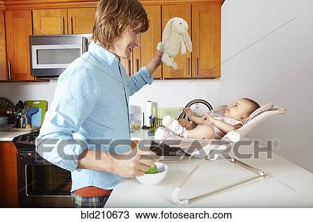 Father playing with baby in chair View Large Photo Image Stock Image - Father playing with baby in chair. Fotosearch