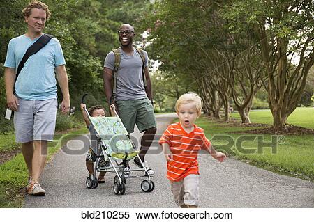 Fathers and sons walking together in park View Large Photo Image Stock Photography - Fathers and sons walking together in park. Fotosearch