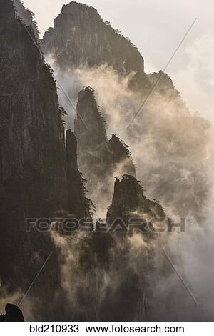 Stock Image - Fog rolling over mountains, Huangshan, Anhui, China,. Fotosearch