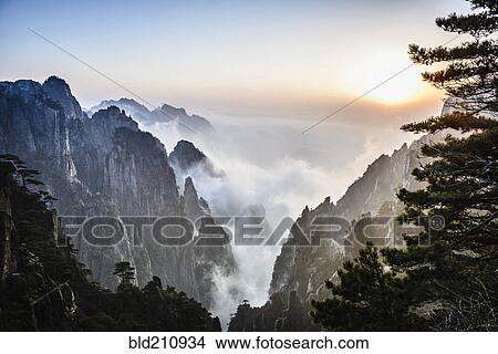 Picture - Fog rolling over rocky mountains, Huangshan, Anhui, China. Fotosearch
