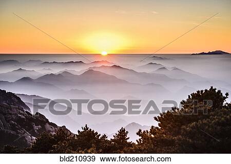Stock Photo - Fog rolling over rocky mountains, Huangshan, Anhui, China. Fotosearch