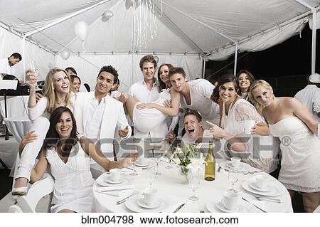 Friends celebrating at party View Large Photo Image Stock Photo - Friends celebrating at party. Fotosearch
