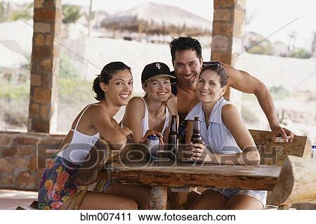 Friends drinking beer outdoors View Large Photo Image Stock Image - Friends drinking beer outdoors. Fotosearch