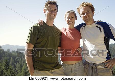 Stock Image - Friends hugging in remote area. Fotosearch