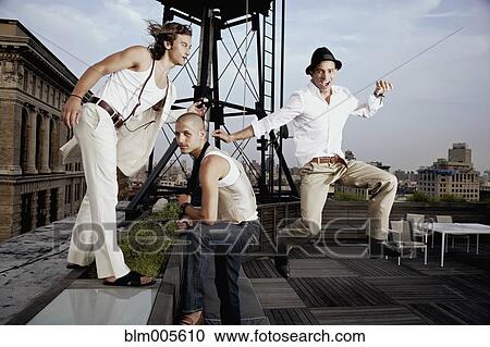 Friends playing on urban rooftop View Large Photo Image Stock Image - Friends playing on urban rooftop. Fotosearch