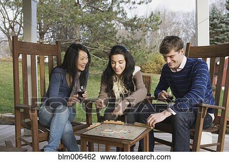 Friends playing scrabble on porch View Large Photo Image Stock Image - Friends playing scrabble on porch. Fotosearch