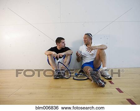 Stock Photograph - Friends resting after racquetball game. Fotosearch